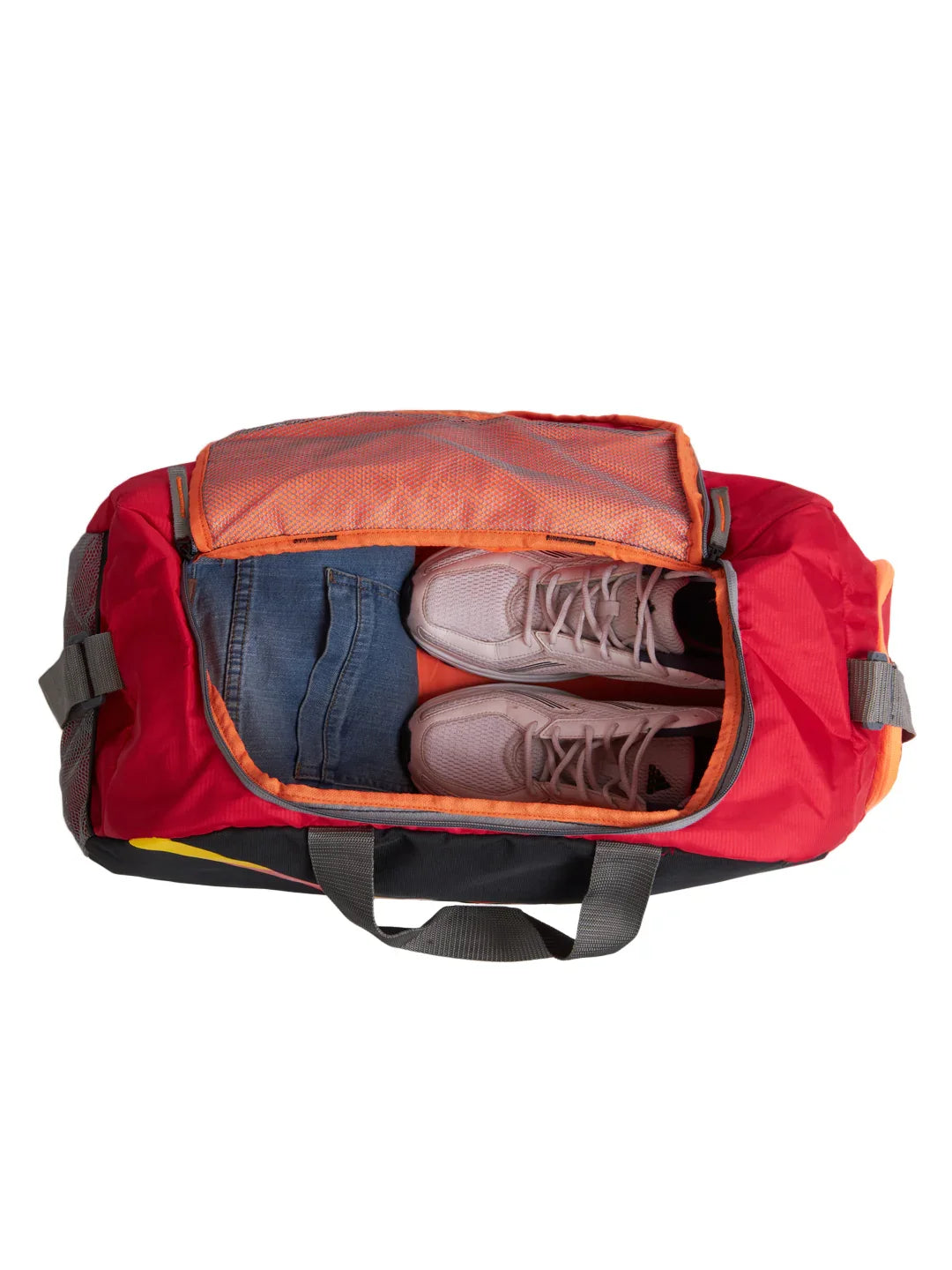 Red duffel bag with shoes and clothes on a white background