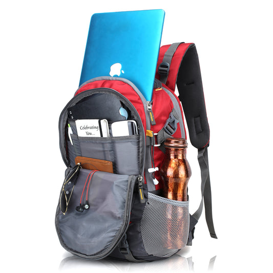 Red and gray backpack with a blue laptop, water bottle, and snacks on a white background