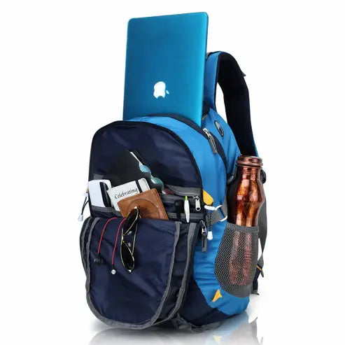 Blue and black backpack with various items on a white background